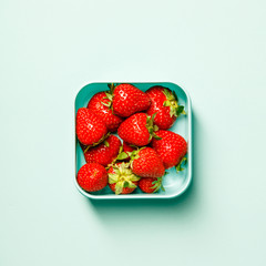 Container with fresh strawberry