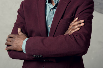 cropped view of stylish african american man with crossed arms in burgundy jacket
