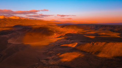 Red earth with iron oxides at sunset aerial view. Beautiful sunset. Martian landscape.