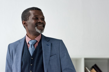 stylish smiling african american man in blue jacket