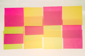 Vintage sticky notes on glass wall.selective focus.