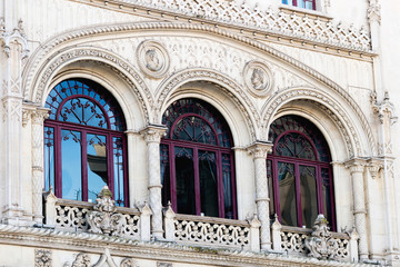 incredible decorative windows in the form of arches in an old building and balconies with beautiful handrails