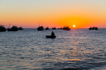 Vietnam Mui Ne village fishing boats and ships in evening sunset light