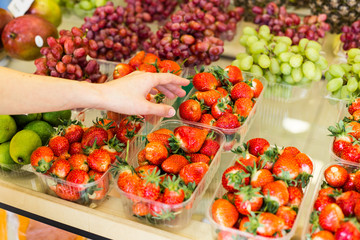 Beautiful Young Woman Groceries Shopping In Local Supermarket