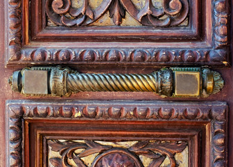 Fragment of old wooden door with rusty handle