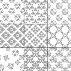 Gray and white floral ornaments. Collection of seamless patterns