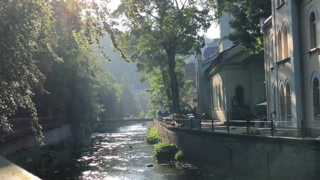Telpa river shining in backlight in Karlovy Vary, Czech Republic