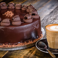 A chocolate mud cake with a cup of coffee