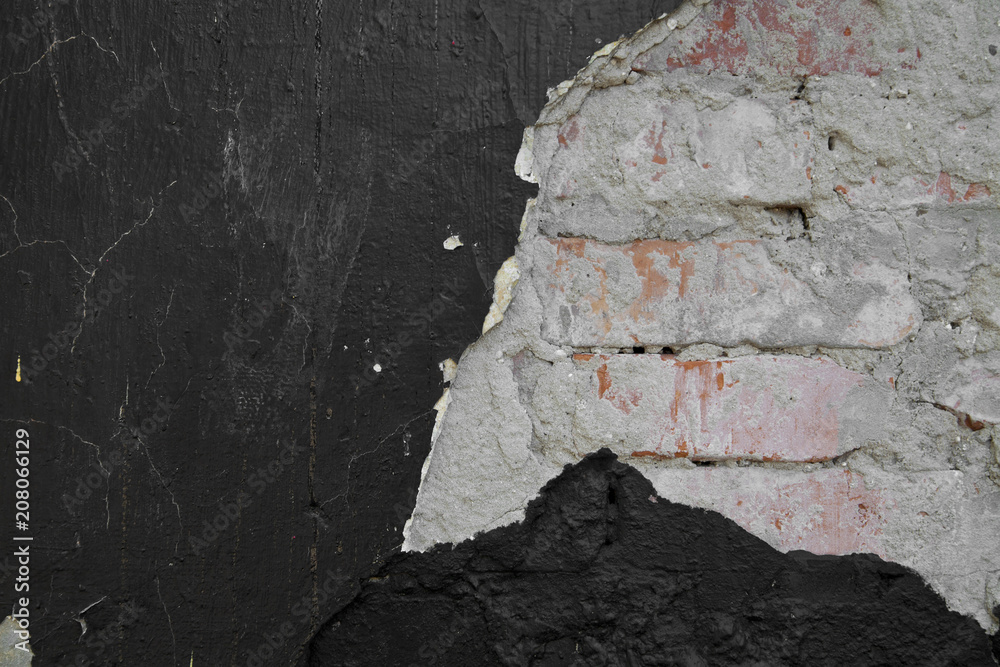 Wall mural texture of a black wall with a red brick