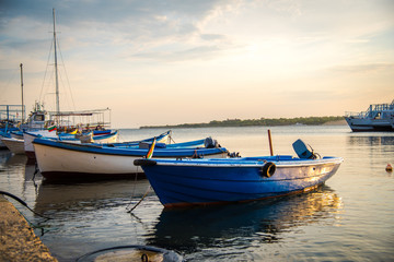 Naklejka na ściany i meble Old boats on Nesebar harbour, Bulgaria. Sunset photo of boats in Black sea