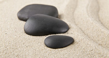Fototapeta na wymiar stones on sand for relaxation as background