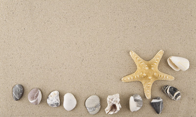 Fototapeta na wymiar starfish, seashells and stones on sand for relaxation as a background