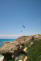 paraglider taking off from seacliff