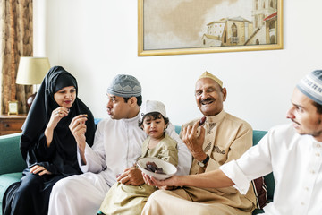 Fototapeta premium Muslim family having dried dates as a snack