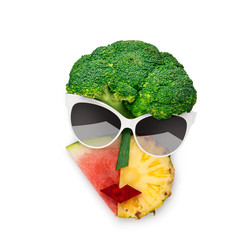 Tasty art / Creative concept photo of cubist style female face in sunglasses made of fruits and...