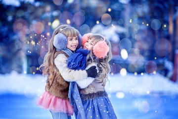 Girls, sisters skate on the ice rink and laugh