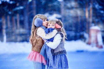Girls, sisters skate on the ice rink and laugh