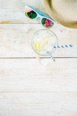 Summer holidays vacation concept background, hat, sunglasses, iced drink (lemonade, mojito), white wooden background copy space