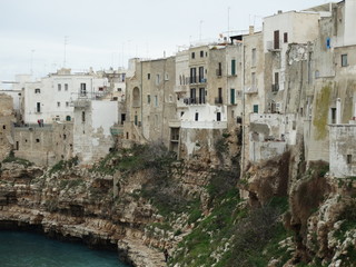 Fototapeta na wymiar White washed buildings in the seaside town of Polignano a Mare, Southern Italy