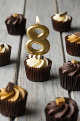 Number 8 celebration birthday cupcakes on a wooden background