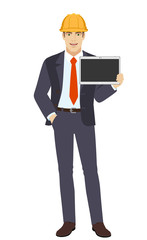 Businessman in construction helmet with hand in pocket showing blank digital tablet PC