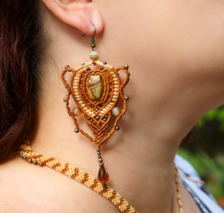 The girl shows ornaments from macrame