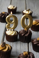 Number 90 celebration birthday cupcakes on a wooden background