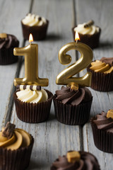 Number 12 celebration birthday cupcakes on a wooden background