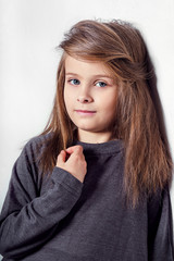 Portrait little fashion kid closeup. Beautiful face caucasian child. Сute model girl looks kind, pensive, calm look.