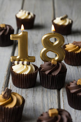 Number 18 celebration birthday cupcakes on a wooden background