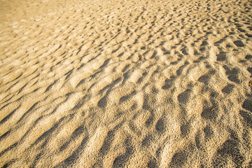 Sand of a beach with wave patterns