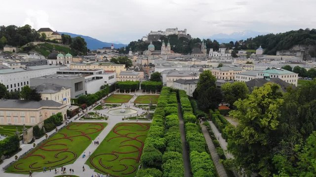Aerial view of cityscape of Salzburg city, famous Mirabell Gardens, Salzburg Cathedral, old historic Fortress Hohensalzburg and Alps mountains in backgroung - landscape of Austria from above, Europe