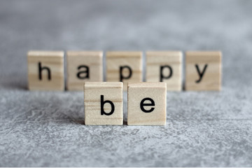 Be happy word written on wood cube