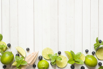 Fresh citrus berries lime mint blueberries on a light background. Copy space for text