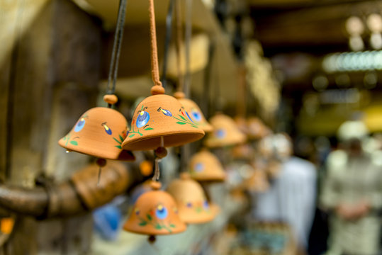 Clay bells hang on a rope. Shallow depth of field