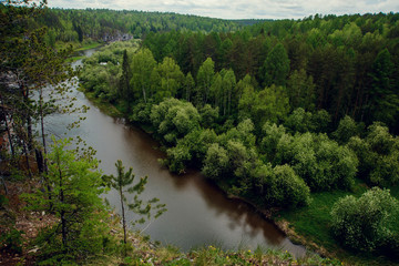 Fototapeta na wymiar The blue ribbon of the river from the height of the mountains. Wild nature, taiga. Tourism. Far East, Sakhalin Island, Russia.