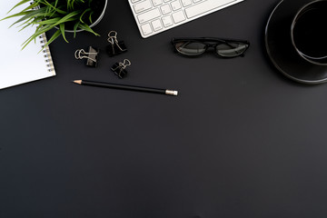 Flat lay of top view modern black desk work table with computer laptop and stationary in home...