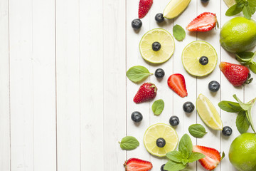 Fresh berries of citrus lime mint blueberries strawberry on a light background. Copy space for text