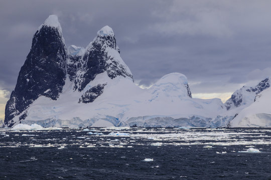 Una Peaks (Una's Tits), basalt ice-capped towers, False Cape Renard, Lemaire Channel entrance, Antarctic Peninsula, Antarctica