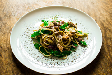 Paste. Italian cuisine, cooked dish on an old background. concepts old recipe. idigrants sauce, spices, peas, young, onion, red onion with pasta