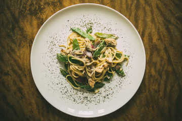 Paste. Italian cuisine, cooked dish on an old background. concepts old recipe. idigrants sauce, spices, peas, young, onion, red onion with pasta