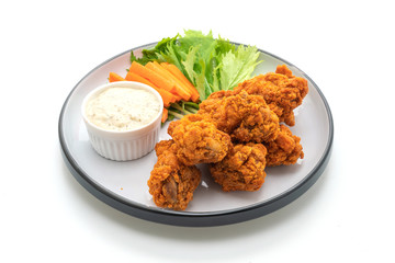 fried spicy chicken wings with vegetable
