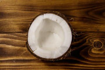 Fresh ripe coconut on rustic wooden table