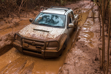 Obraz na płótnie Canvas Ute stuck in the mud four wheel driving in Australian outback
