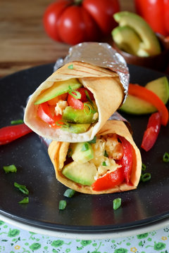 Burrito with vegetables and fried eggs. Mexican cuisine meal