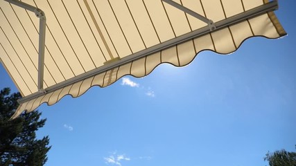 awning opening against blue sky on sunny day