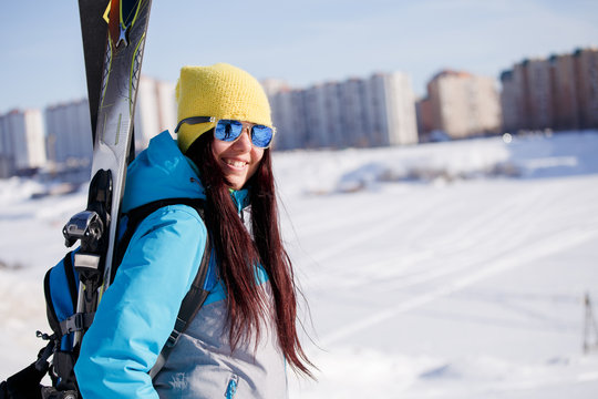 Photo of happy sports woman with skis and sticks in winter