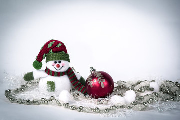 cute toy snowman and various Christmas decorations on a white b