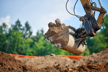 Backhoe - Bulldozer in open field operation