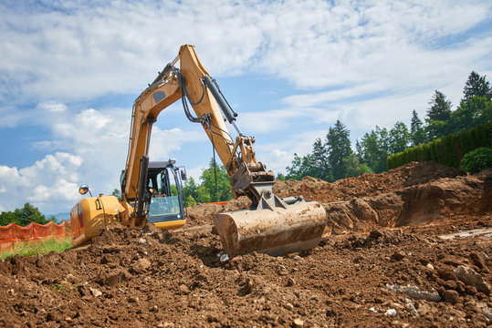 Excavator At Construction Site - Digging Foundations For House